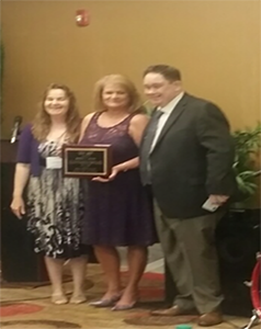 Anna Shelton and Eddie Turner presenting Wanda Allen with the Frankie Thames Service Award